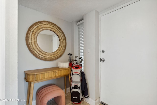 entryway with a textured ceiling