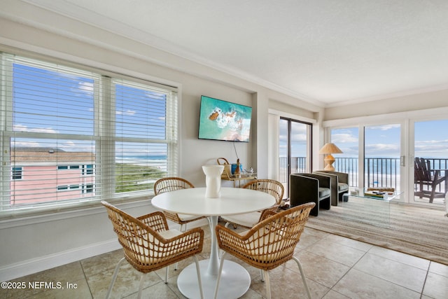 dining room featuring light tile patterned floors and ornamental molding