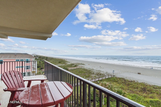 balcony with a beach view and a water view