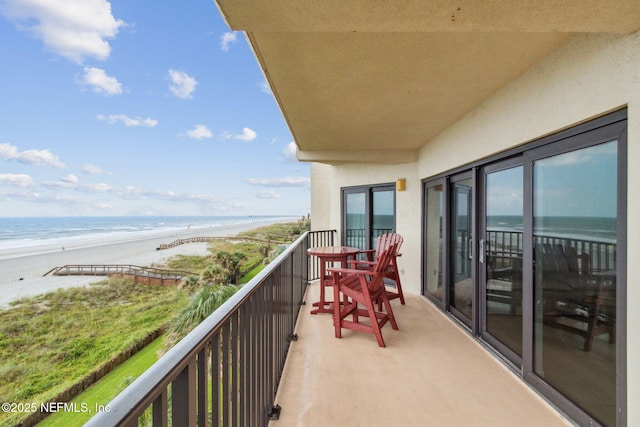 balcony with a view of the beach and a water view