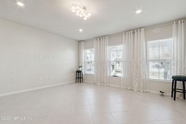 empty room featuring a wealth of natural light and light tile patterned flooring