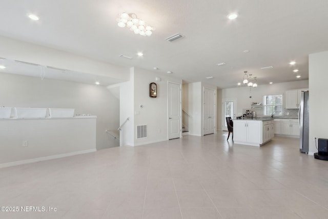 unfurnished living room featuring light tile patterned floors