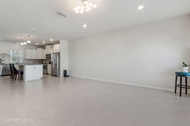 living room with a notable chandelier and light tile patterned flooring