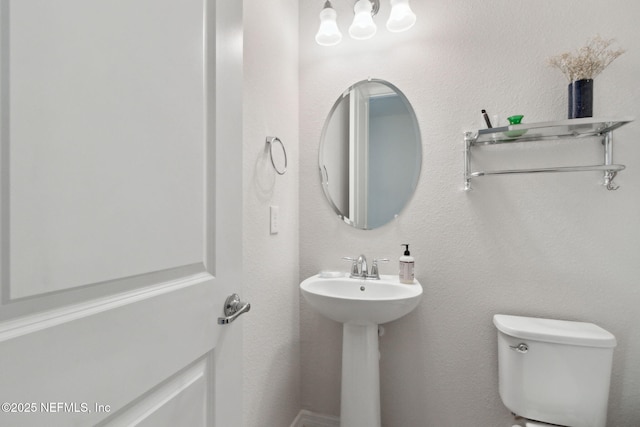 bathroom featuring toilet and sink