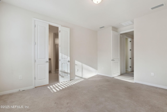 spare room featuring light colored carpet