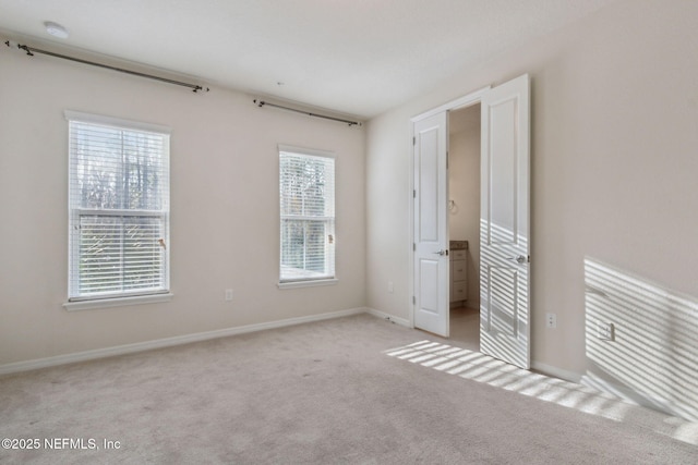 unfurnished bedroom featuring light carpet