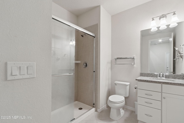 bathroom featuring tile patterned floors, vanity, toilet, and a shower with shower door