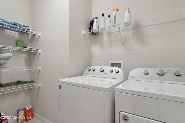 clothes washing area with independent washer and dryer