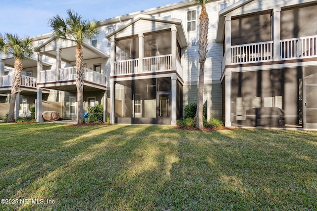 rear view of property featuring a lawn