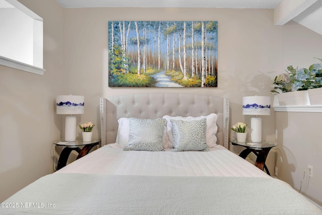 bedroom featuring beam ceiling