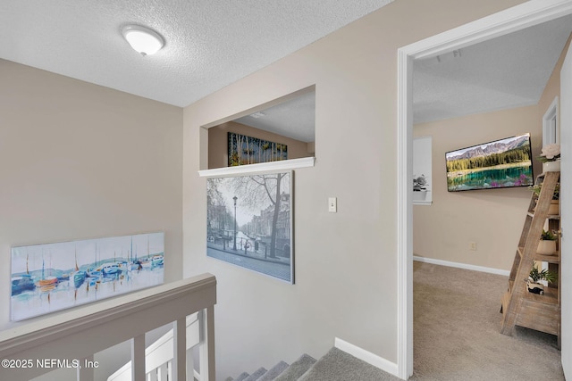 hallway with a textured ceiling, light carpet, and vaulted ceiling