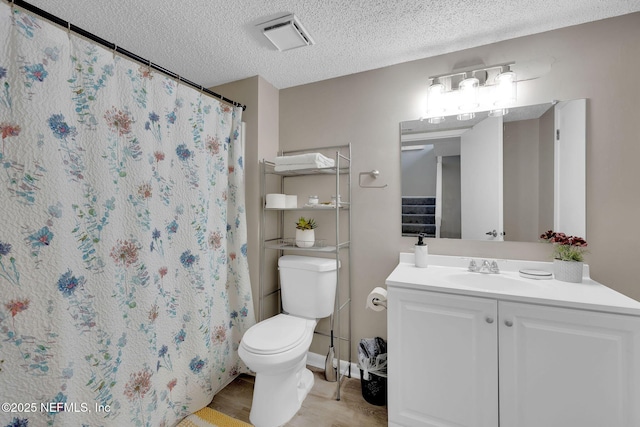 bathroom featuring vanity, a textured ceiling, wood-type flooring, toilet, and curtained shower