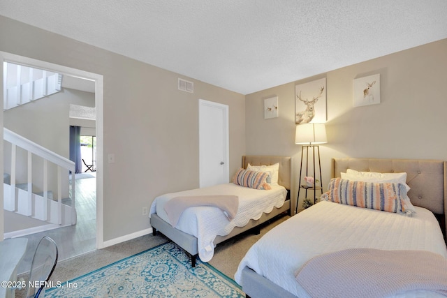 carpeted bedroom with a textured ceiling