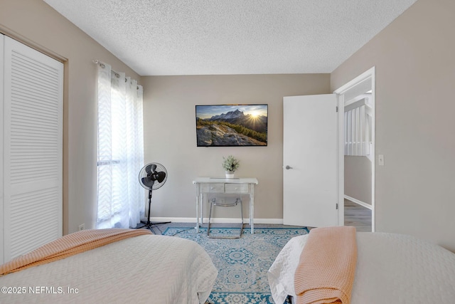 bedroom with a closet and a textured ceiling