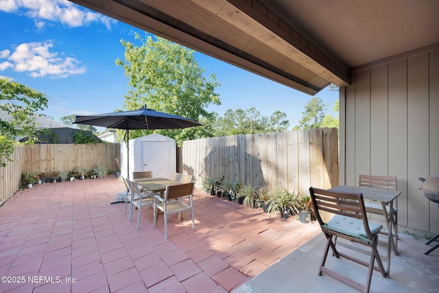 view of patio featuring a storage unit