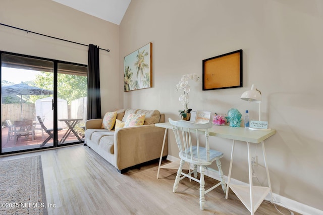 living room featuring light hardwood / wood-style flooring and lofted ceiling