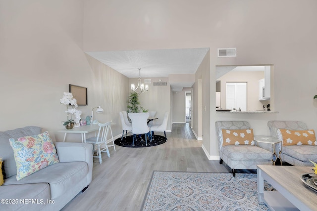 living room featuring light hardwood / wood-style flooring and a chandelier