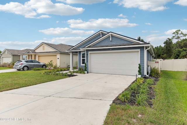 view of front of property featuring a garage and a front lawn