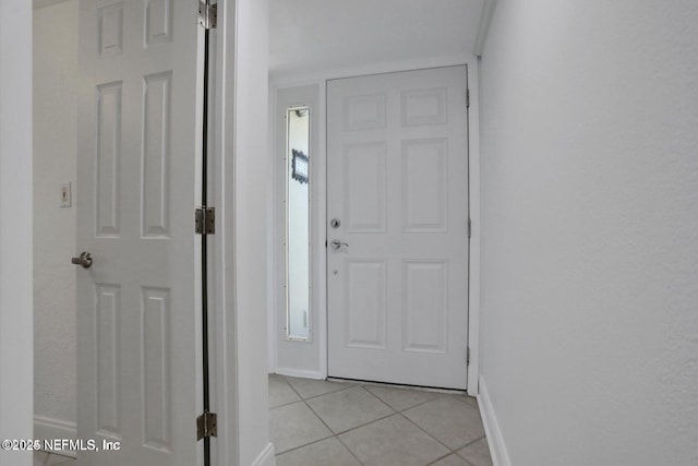 interior space featuring crown molding and light tile patterned floors