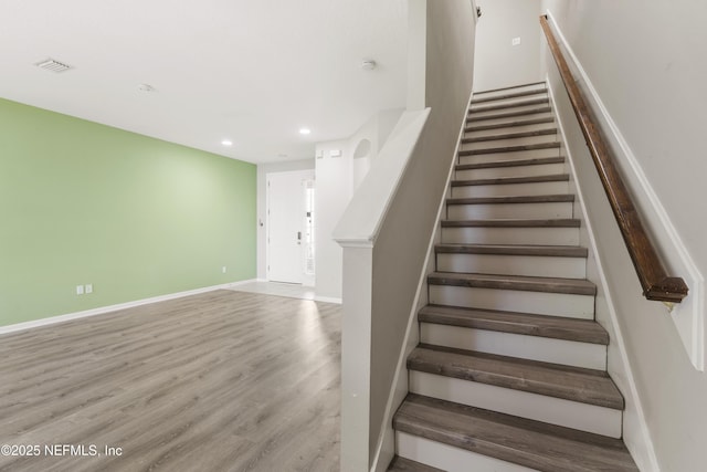 staircase featuring hardwood / wood-style floors