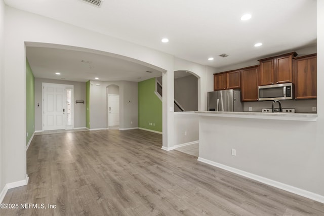 kitchen featuring light wood-type flooring and appliances with stainless steel finishes