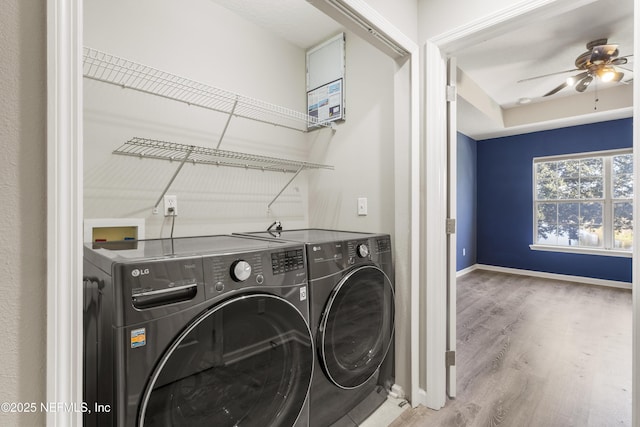 laundry area featuring ceiling fan, wood-type flooring, and separate washer and dryer