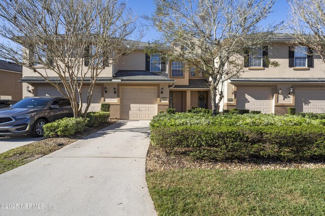 multi unit property featuring a garage