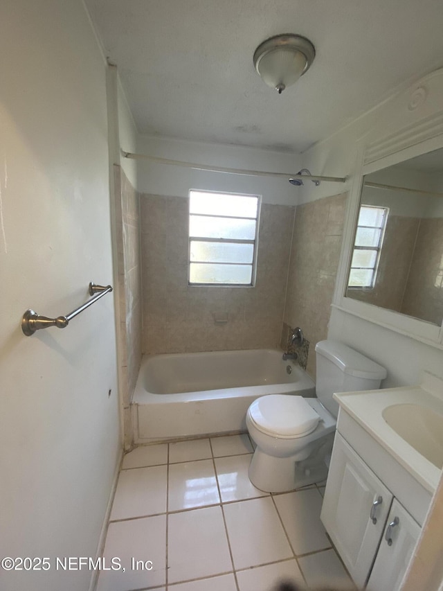 full bathroom with tile patterned flooring, vanity, toilet, and tiled shower / bath