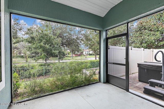 unfurnished sunroom with lofted ceiling