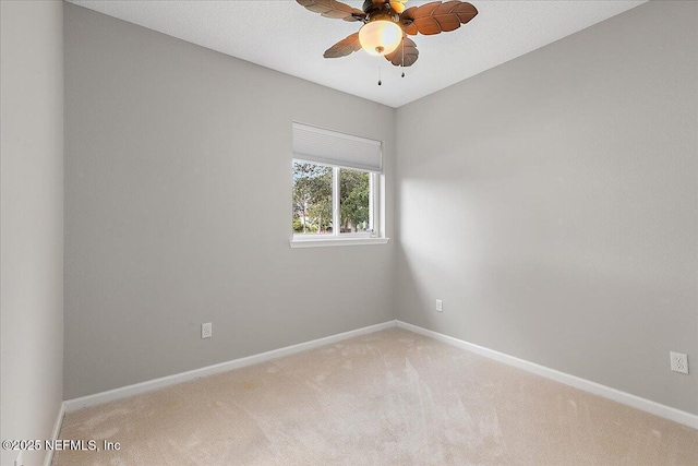 spare room with carpet flooring and ceiling fan