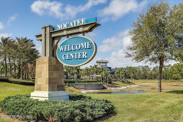 community / neighborhood sign with a lawn