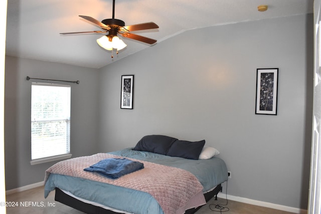 bedroom featuring light colored carpet, vaulted ceiling, and ceiling fan