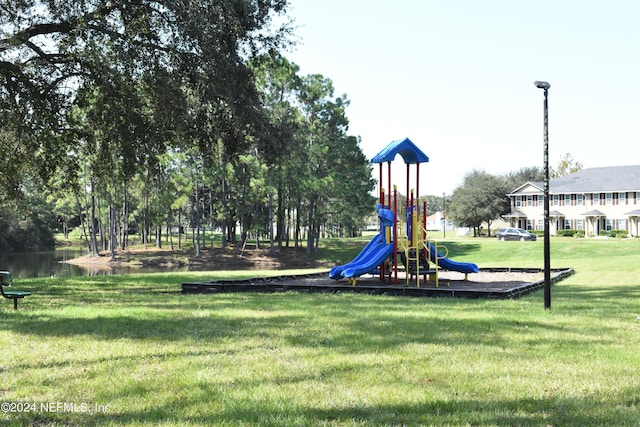 view of jungle gym with a yard and a water view