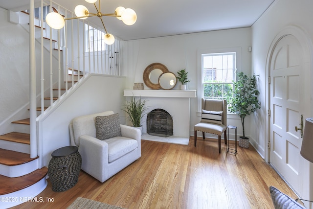 living area featuring hardwood / wood-style floors and a chandelier