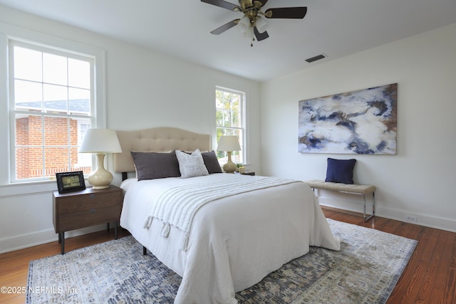 bedroom with dark wood-type flooring and ceiling fan