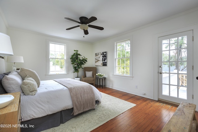 bedroom with multiple windows, ornamental molding, and dark hardwood / wood-style floors