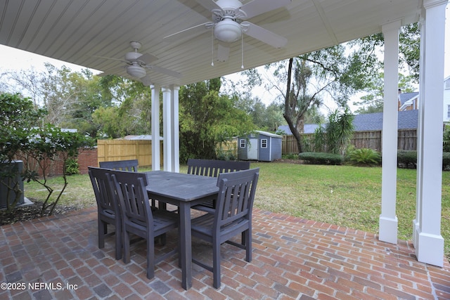 view of patio featuring ceiling fan and a storage shed