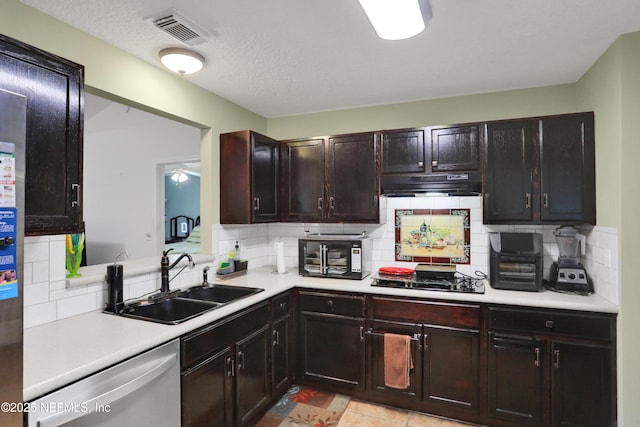 kitchen with tasteful backsplash, stainless steel dishwasher, a textured ceiling, sink, and black stovetop