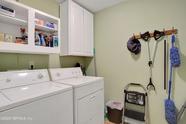 laundry room featuring separate washer and dryer and cabinets