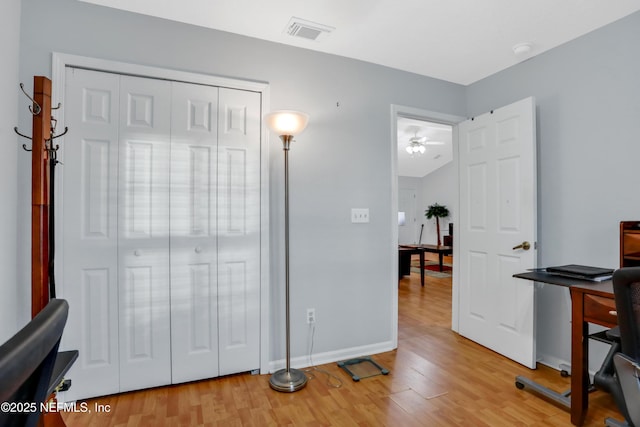 home office with ceiling fan and light wood-type flooring