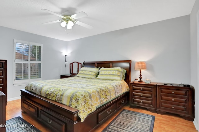 bedroom with ceiling fan and light hardwood / wood-style flooring