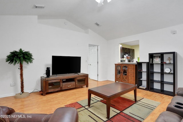 living room with lofted ceiling and hardwood / wood-style flooring