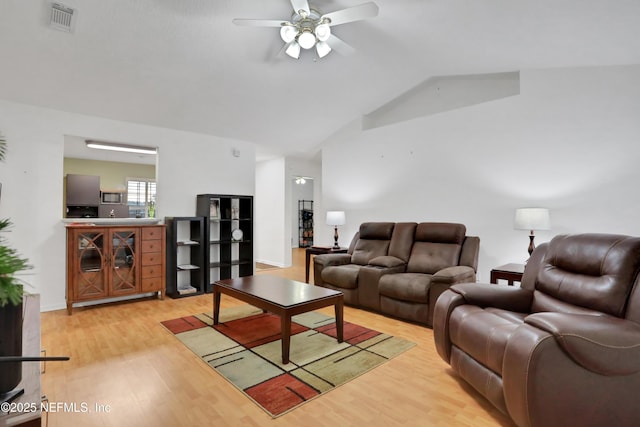 living room featuring light wood-type flooring, ceiling fan, and lofted ceiling