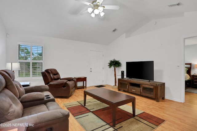 living room with light hardwood / wood-style floors, vaulted ceiling, and ceiling fan