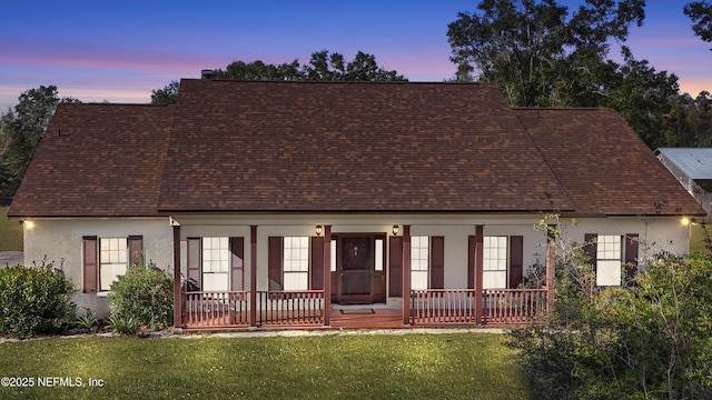 view of front of home featuring a porch and a yard