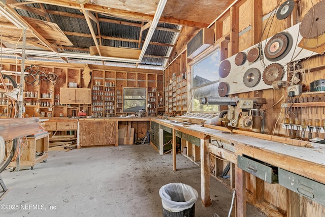 miscellaneous room with a workshop area and concrete floors