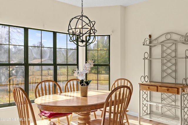 dining space featuring tile patterned flooring and a chandelier