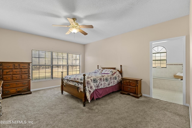 carpeted bedroom featuring connected bathroom, multiple windows, ceiling fan, and a textured ceiling