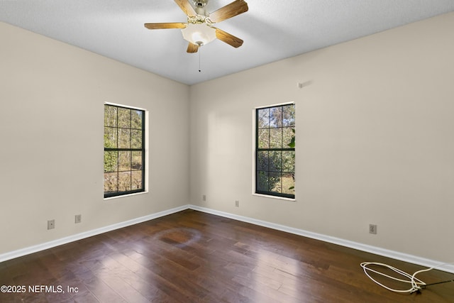 spare room featuring ceiling fan, dark hardwood / wood-style flooring, and a textured ceiling