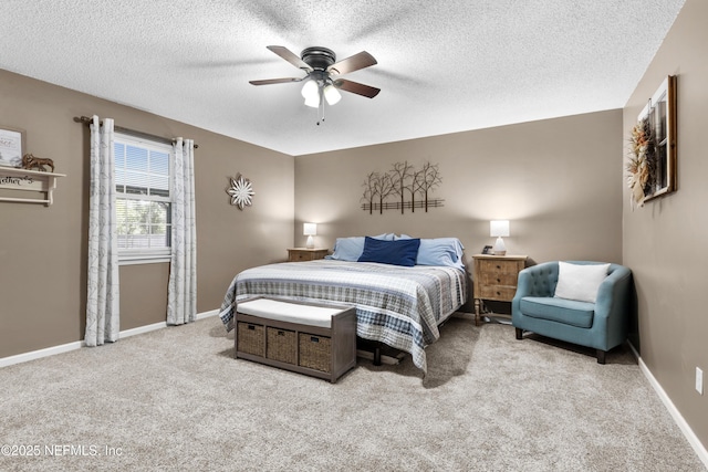 bedroom with light carpet, ceiling fan, and a textured ceiling